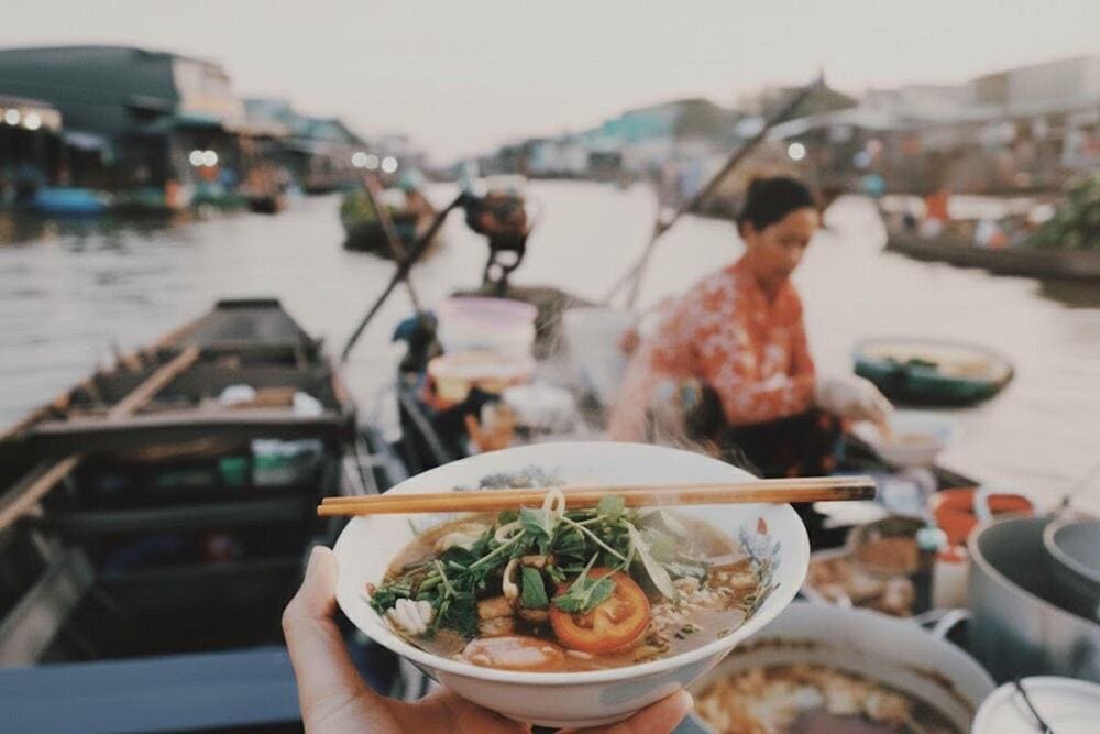 A steaming hot bowl of bun rieu on the boat is an unforgettable experience